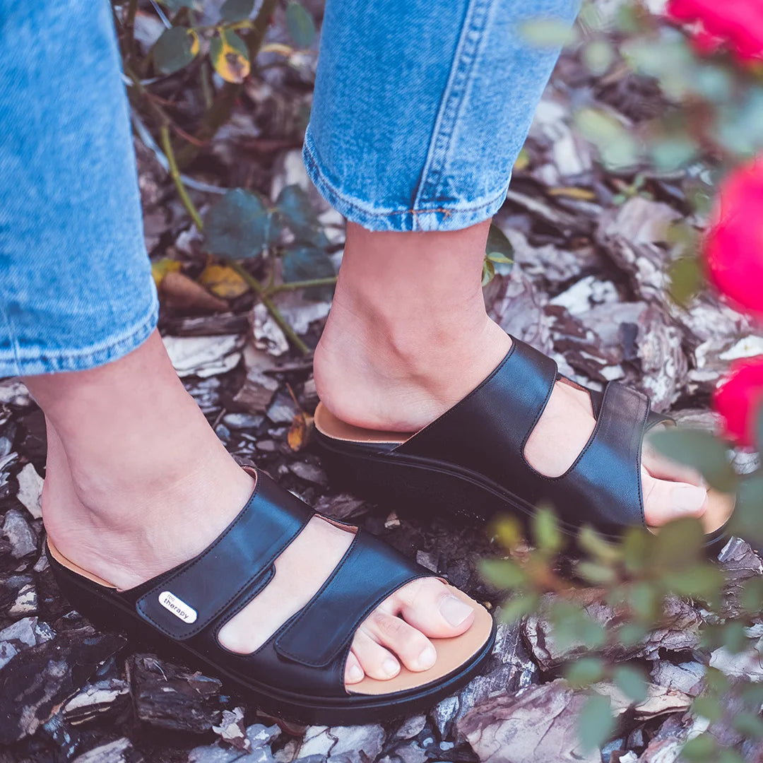 Woman walking comfortably in wide fitting rocker sole sandals by TDO Therapy, ideal for plantar fasciitis relief.